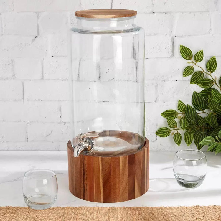 Premium glass beverage dispenser with wooden base and stainless steel spigot.