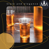 Crystal mugs with handles in a glass tea cup set arrangement on table.